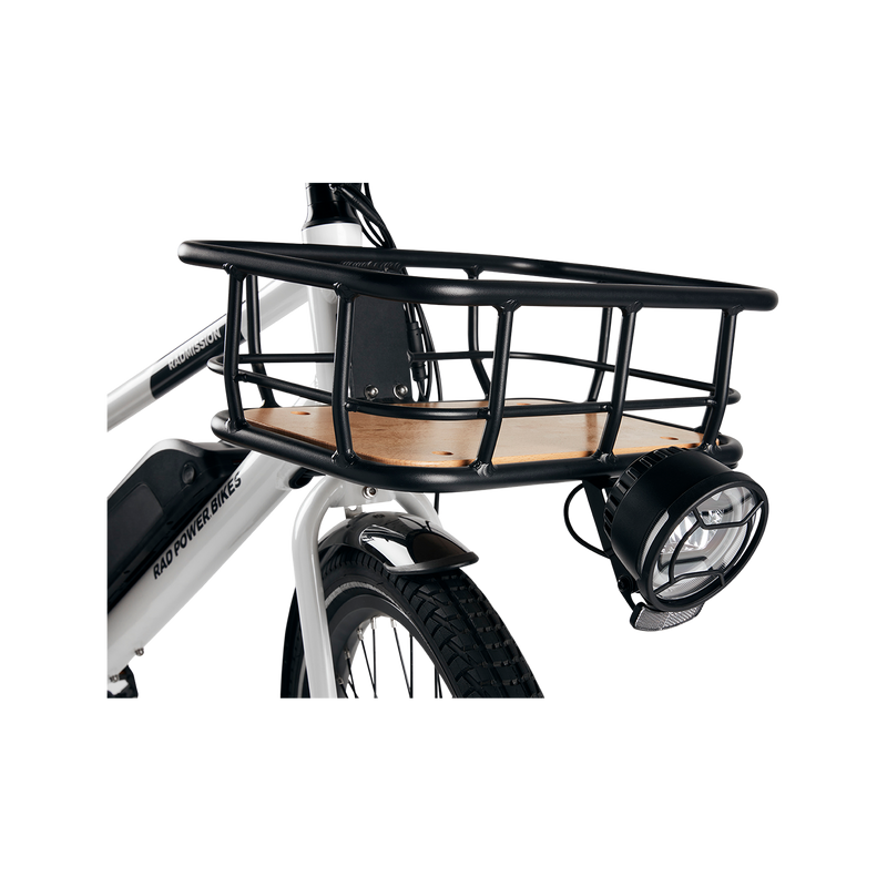 A headlight mounted to a front basket on the front of a grey Ebike