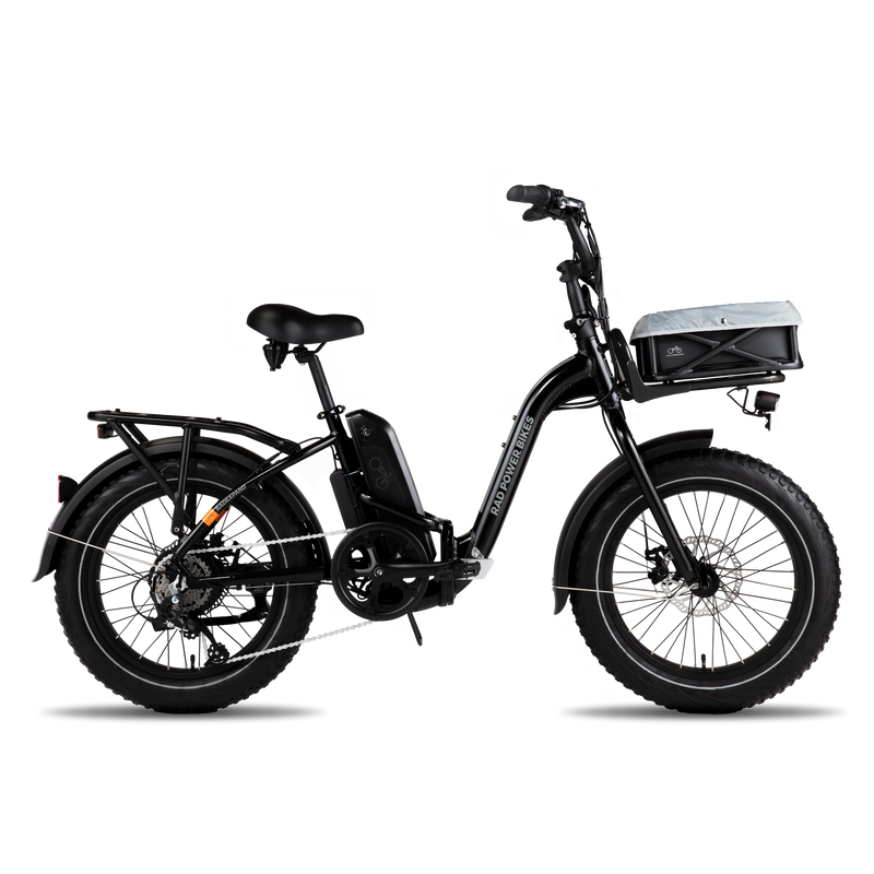 A side view of an ebike with a front basket that contains a pet liner. 