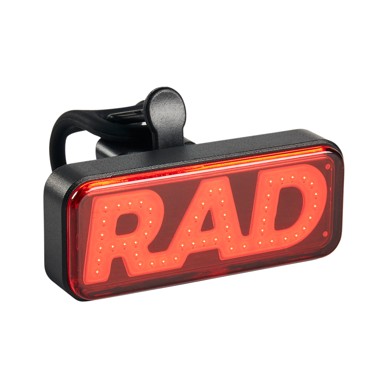 Close up picture of Rad Power Bikes Rad logo taillight not on a bike where you can see part of the mounting strap.