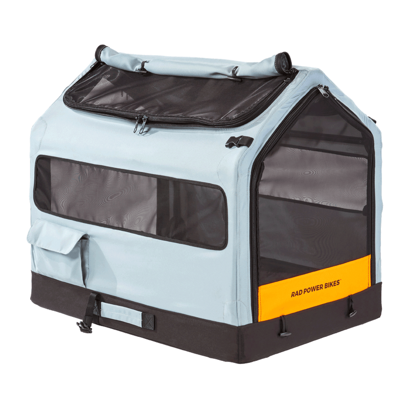 Side view of the Rad Trailer Pet Insert, showing how the top window unzips and the side pocket for extra storage. Also shows reflector on the rear door.
