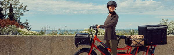 A woman rides her RadWagon electric cargo bike for deliveries.