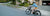 A woman rides a RadMission electric metro bike up a hill in her neighborhood.