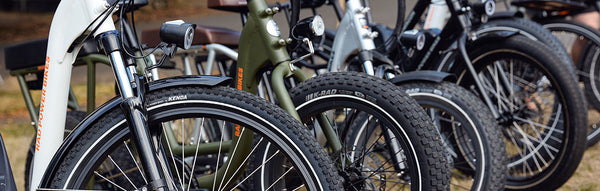 A selection of electric bikes from Rad Power Bikes lined up alongside each other.