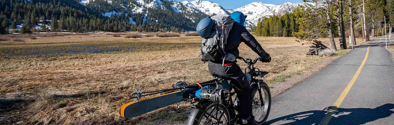 Rad Power Bike rides toward snow-capped mountain.
