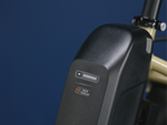 Black ebike battery against a blue background