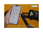 A hand holding a cell phone showing a map close to the display on a green ebike. 