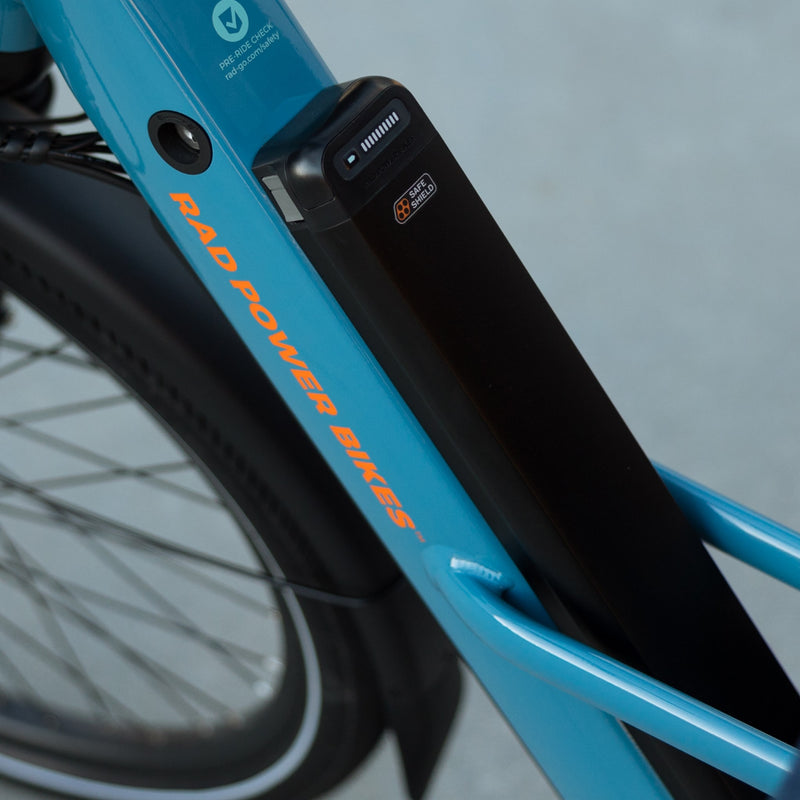 Safe Shield Advanced Semi-Integrated battery installed on a blue Radster Road electric commuter bike