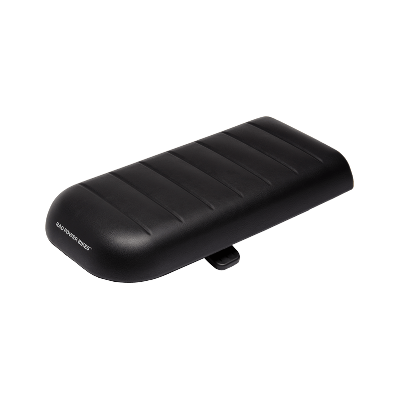 RadWagon deckpad, used for passenger seating on a RadWagon electric cargo bike. Black vinyl material with padding. Subtle Rad Power Bikes logo along the end.