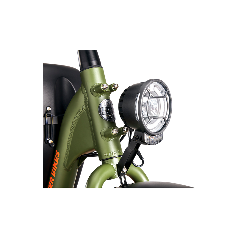 A premium headlight with a reflector mounted on a green Ebike