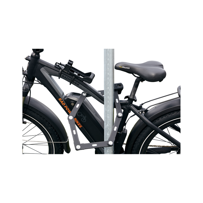 Close up side view of ABUS Bordo Granit X-Plus 6500 Folding Lock safely locking an ebike through the frame to a bike rack.