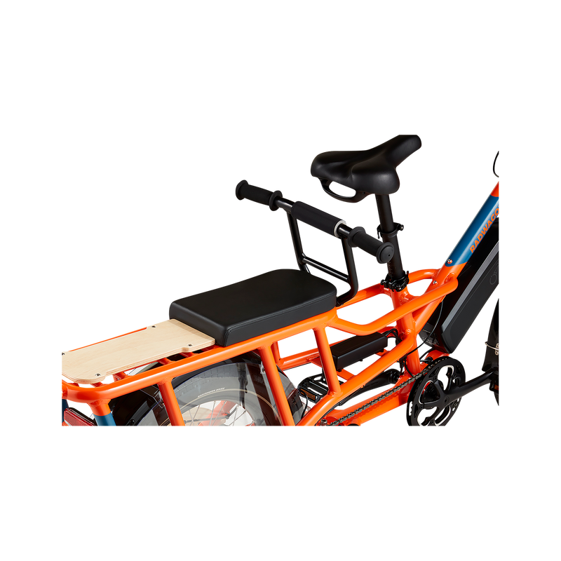 A closeup view of an orange RadWagon showing a black Deckpad cushion mounted on the rear of the bike, with a Deckhand in front.