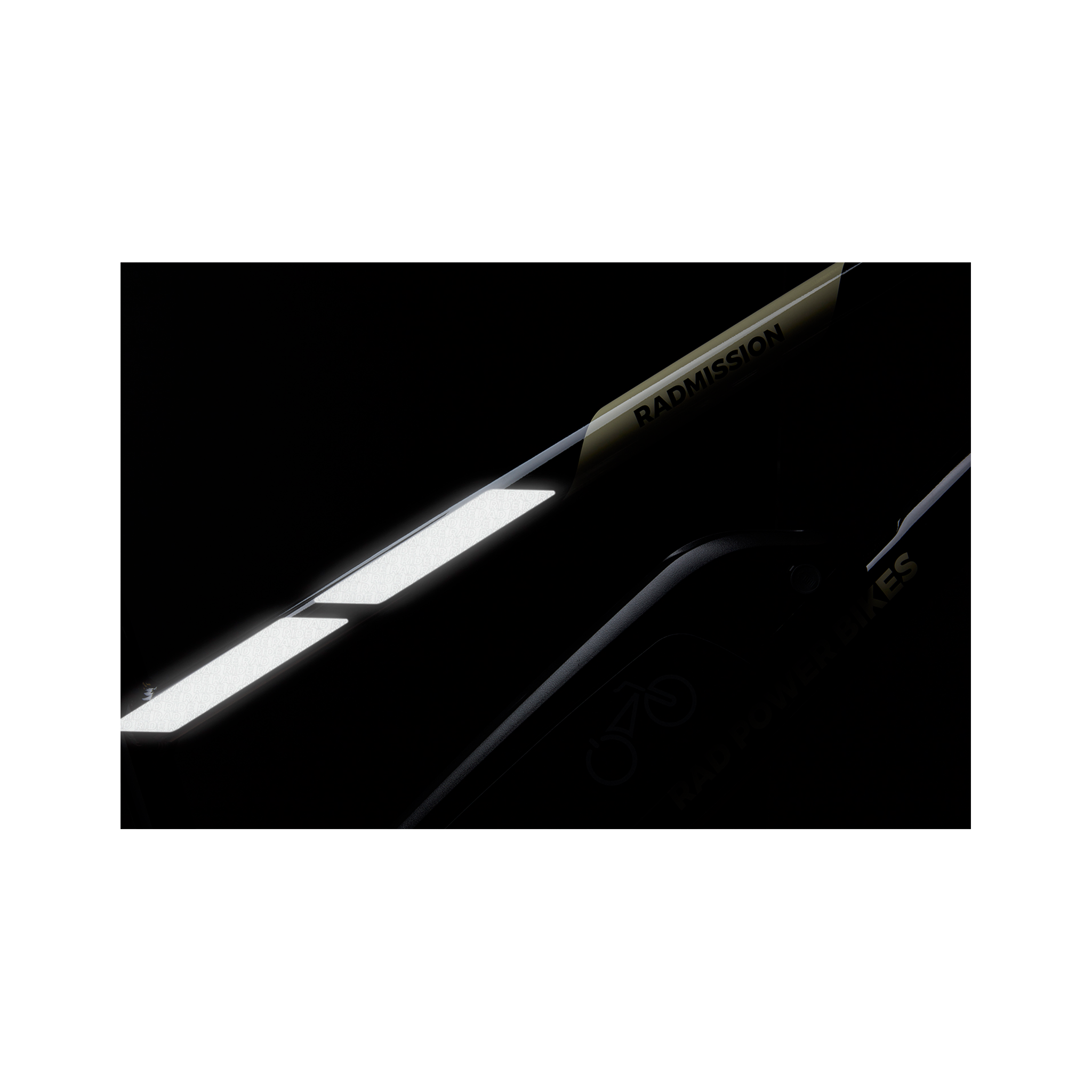 Detail view of a RadMission top tube showing how installed Reflective Safety Stickers look in low light on a black background