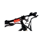 Close up photo of Rad Power Bikes Rad logo taillight mounted on the handlebars of a Rad Mission electric bike.