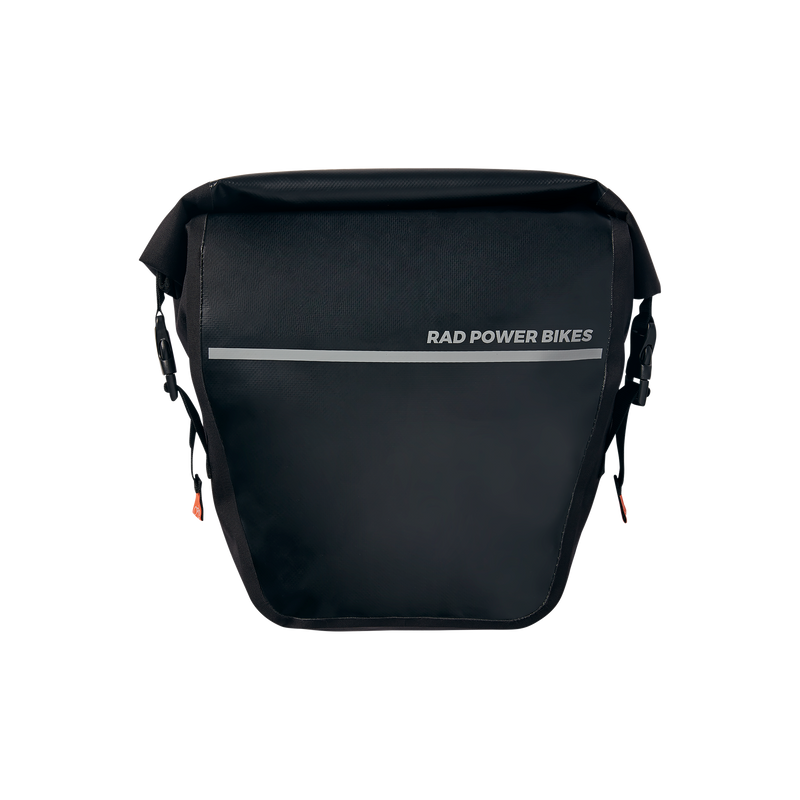 Close up side view of black Fremont Pannier Bag rolled closed with side straps attached and silver reflective strip across the side.