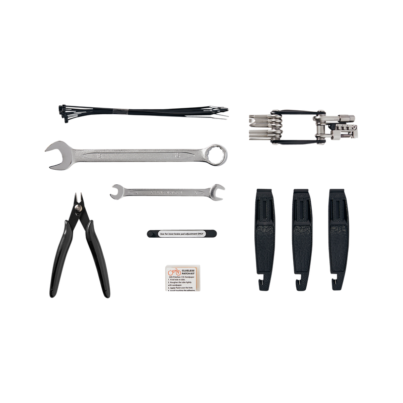 Detailed view of the tools included in the Roadside Repair Tool Kit: 18 mm Wrench, 8 / 10 mm Wrench, Flat-side Cutters, Brake Inner Pad Adjustment Tools, 3 Tire Levers, Glueless Patch Kit, and a Multi-tool featuring a