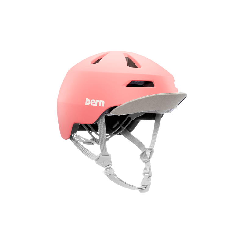 Front view of a pink Bern kids' helmet with a gray visor flipped up