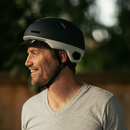 Man wearing a blue Bern x Rad helmet 
