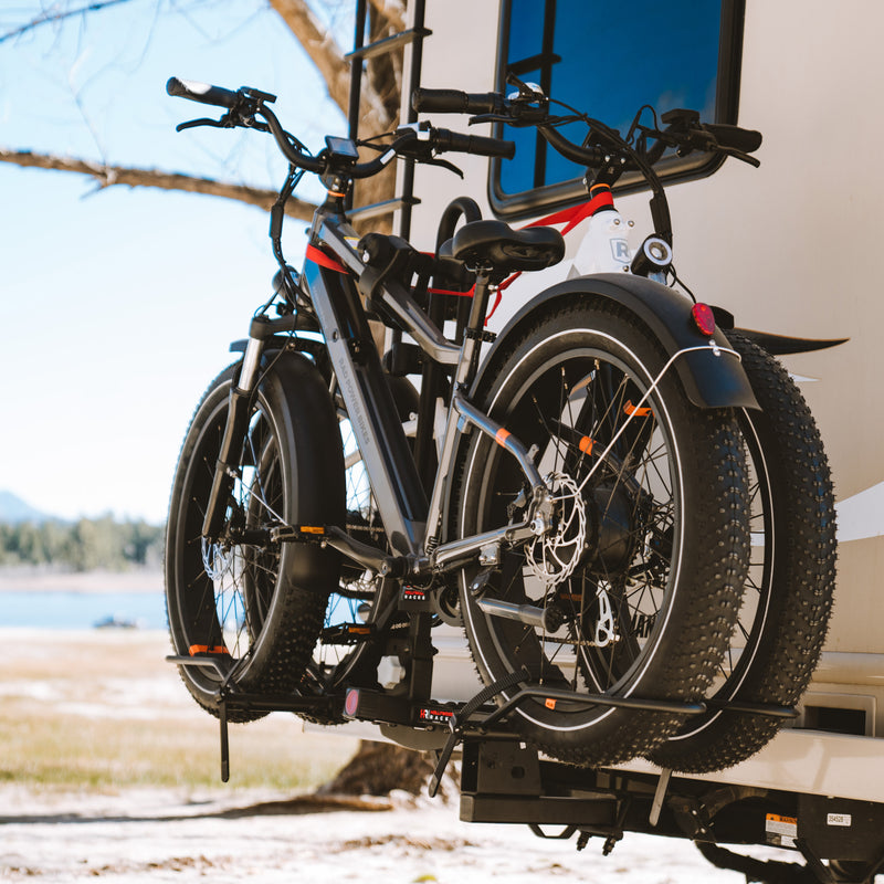 Lifestyle photo of two ebikes on an RV Rider Rack mounted on an RV