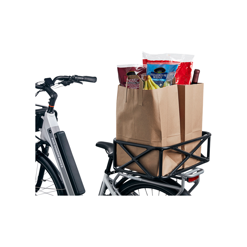 Top and side section view of Large Basket attached to the rear rack of a white ebike. The basket is perpendicular to the ebike and holds two fully-loaded large paper bags of groceries.