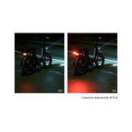 Two side by side photos of a Rad Power Bikes RadRunner electric cargo bike with passenger package parked at night on a damp street, one with Rad logo taillight turned on and one with taillight turned off . Both are mounted below rear seat on the rack.