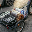 Rad Trailer attached to an electric bike with the pet insert attached and a cute dog inside the pet carrier.